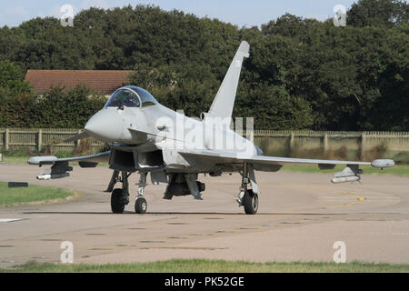 RAF Typhoon from the wing at Coningsby taxiing onto the runway prior to a morning departure to the local range. Stock Photo