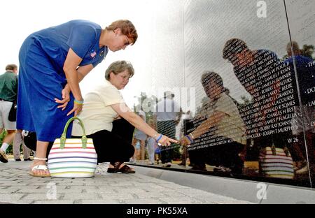 Washington, D.C. - June 29, 2005 -- Lois Diehl, left, and Diane Horning, left center, look at the Vietnam Veteran's Memorial in Washington, D.C. on June 29, 2005.  Ms. Diehl, who lost her husband Michael, and Ms. Horning who lost her son, Matthew, in the World Trade Center collapse on September 11, 2001, are in Washington to lobby against the International Freedom Center (IFC). Credit: Ron Sachs / CNP / MediaPunch Stock Photo