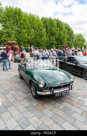Green MGB roadster convertible and people at a car show in Salisbury UK Stock Photo