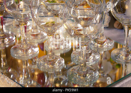 Empty champagne glasses on the mirror wedding table. Used as background. Stock Photo