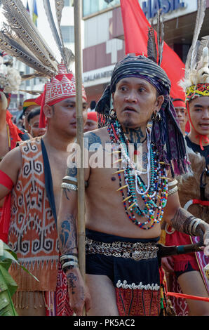 Iban warriors at the Gawai parade with traditional headdress, feathers and costume, Kuching, Sarawak, Malaysia, Borneo Stock Photo