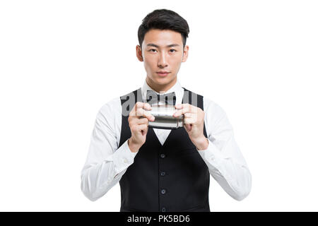 Cheerful young bartender shaking drinks Stock Photo