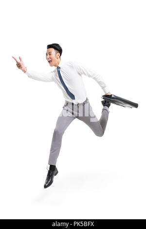 Cheerful young businessman jumping Stock Photo