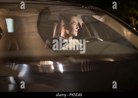 Cheerful chauffeur driving car Stock Photo