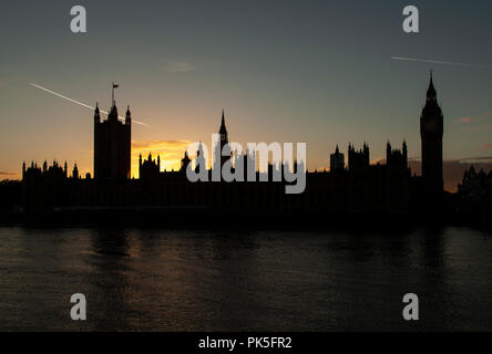 The Houses of Parliament in London, England silhouetted by a golden sunset.