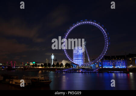 LONDON EYE, LONDON - AUGUST 02 2012. Also known as Millennium Wheel. Shot at night when the Wheel is kit up by LED lighting To match County Hall Stock Photo
