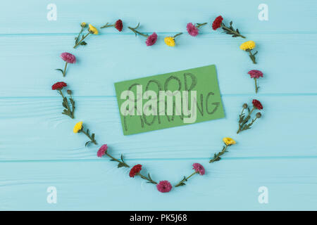 Heart dahlia flowers composition, good morning wish. Blue wooden background. Top view, flat lay. Stock Photo