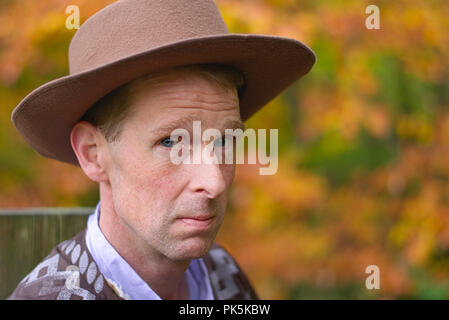 A headshot of a middle aged man wearing a cowboy style hat Stock Photo