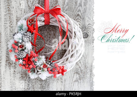 Christmas wreath with red ribbon on a vintage wooden background. Copy space. Beautiful Christmas Background Stock Photo