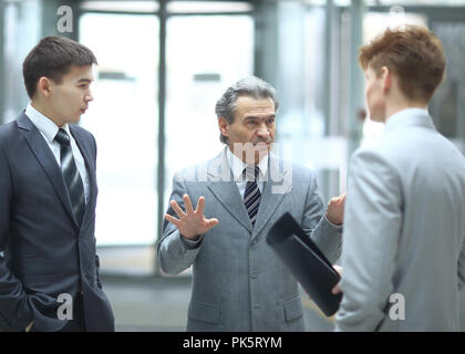 strict boss talking with an employee.photo on blurred office background Stock Photo