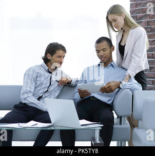 business team reading text on a digital tablet Stock Photo