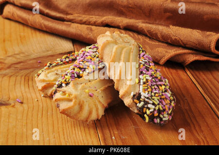 gourmet shortbread cookies dipped in chocolate on a rustic wooden counter top. Stock Photo