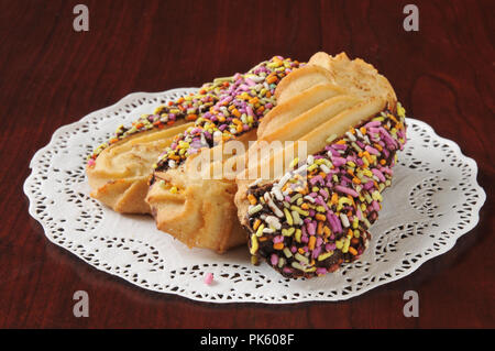 Gourmet shortbread cookies dipped in chocolate and covered with candy sprinkles Stock Photo