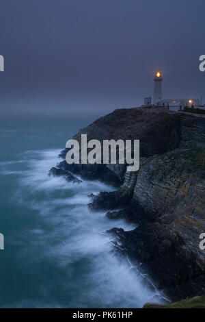 South Stack lighthouse in fog on the coast of Anglesey, North Wales Stock Photo