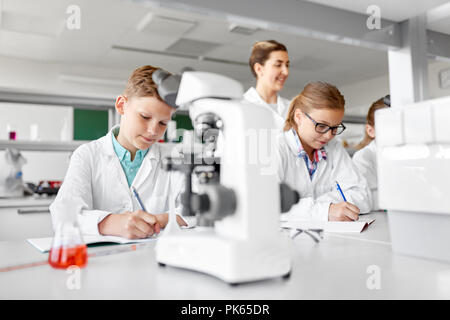 teacher and students studying chemistry at school Stock Photo