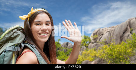 happy woman with backpack over seychelles island Stock Photo