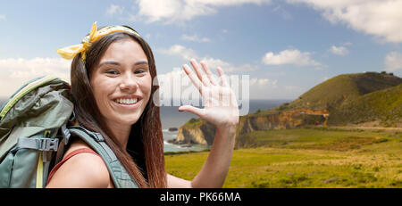 smiling woman with backpack on big sur coast Stock Photo
