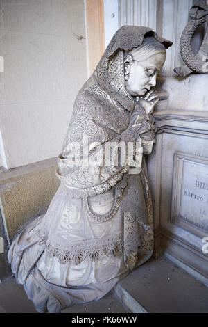 Picture and image of the stone sculpture of a mouring women in the Bourgeois Realistic style. Badaracco Tomb sculpted by G Moreno 1878. The monumental Stock Photo
