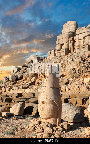 Statue head at sunrise of Apollo in front of the stone pyramid 62 BC Royal Tomb of King Antiochus I Theos of Commagene, east Terrace, Mount Nemrut or  Stock Photo
