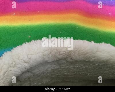 Soft furry fabric on multicolored background. Stock Photo