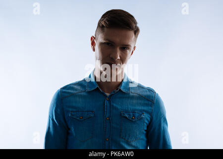 Serious nice man looking in front of him Stock Photo
