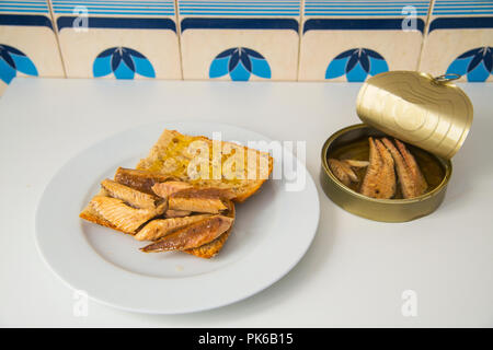 Mackerel fillets with olive oil on bread, and the rest of mackerel in a can. Still life. Stock Photo