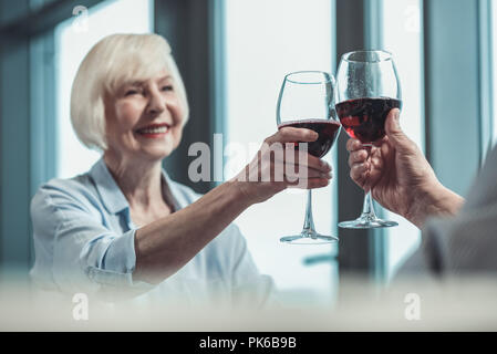 Focused photo on hands that touching bocals Stock Photo