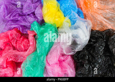 Different plastic bags on old wooden background. Top view. Stock Photo