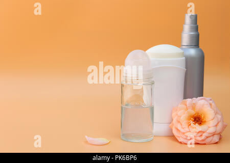 Different deodorants on beige background Stock Photo