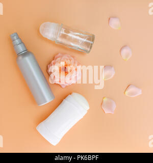 Different deodorants on beige background. Top view. Stock Photo