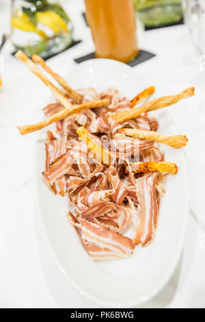 Pancetta and Bread Sticks in White Fine Food Plate Stock Photo