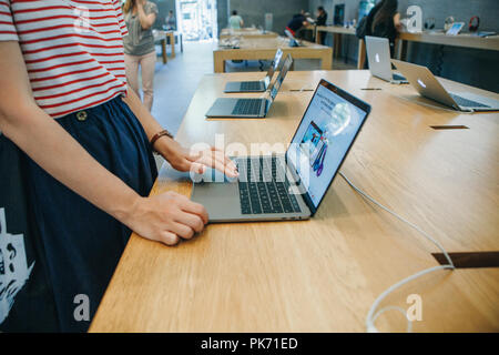 Berlin, August 29, 2018: The buyer chooses to buy a new MacBook in the official store of Apple in Berlin. Stock Photo