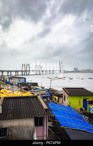 Iconic Sea Link of Mumbai taken from the Worli side with the boats floating in the ocean during heavy monsoons Stock Photo