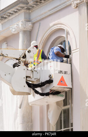 Workers Attach Hurricane Cloth To Windows On The Charleston City