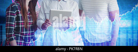 Composite image of businessman explaining to colleagues over tablet Stock Photo