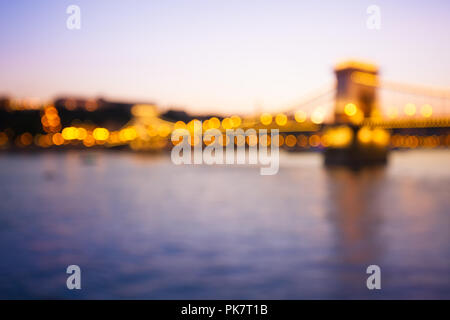 Chain bridge in Budapest with bokeh of city lights, blurred defocused background Stock Photo