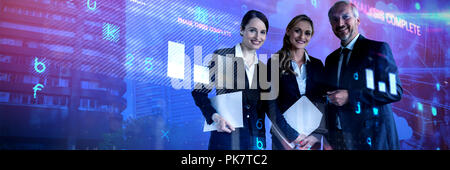 Composite image of smiling colleagues standing against white background Stock Photo