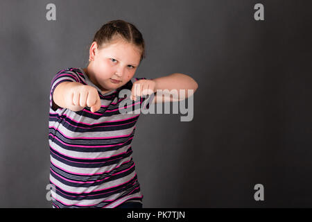 Strong stout girl in an attacking boxing rack Stock Photo