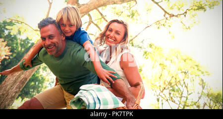 Family arriving in the park for picnic on a sunny day Stock Photo