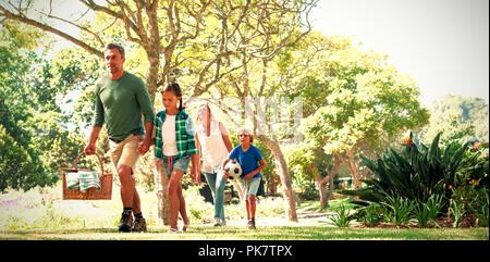 Family arriving in the park for picnic Stock Photo