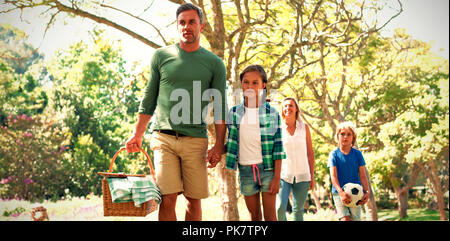 Family arriving in the park for picnic Stock Photo