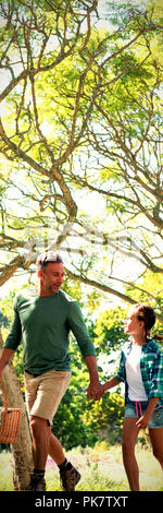 Family arriving in the park for picnic Stock Photo