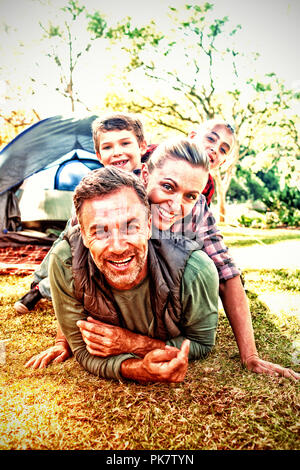 Family stacking on each other outside the tent Stock Photo