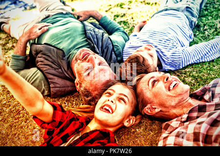 Happy family lying on the grass Stock Photo