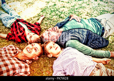 Happy family lying on the grass Stock Photo