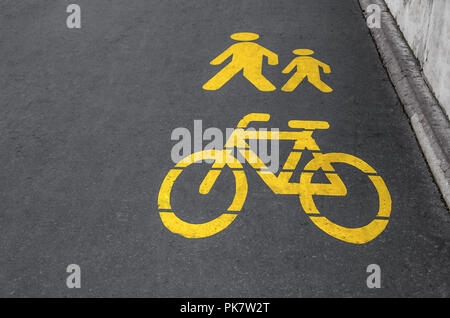 Sign of pedestrian and bicycle paths on the pavement. Stock Photo