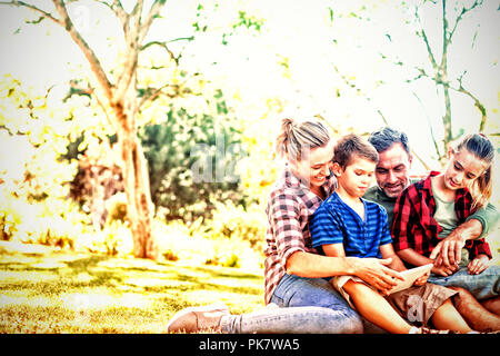 Family using digital tablet in the park Stock Photo