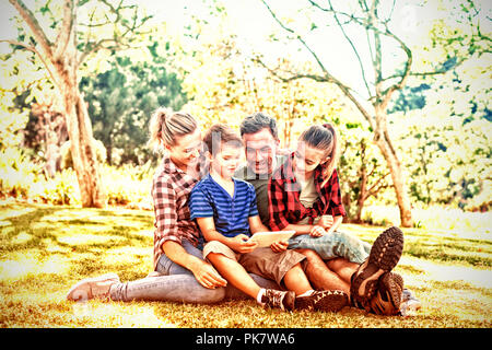 Family using digital tablet in the park Stock Photo