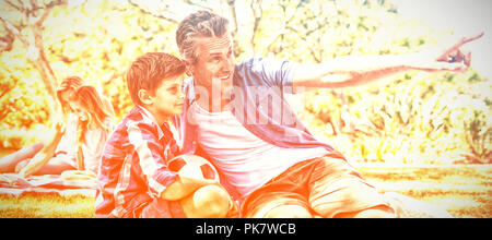 Father and son looking at the distance in park Stock Photo