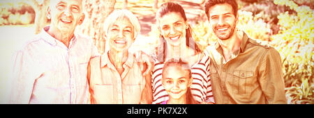 Happy family standing together in the park Stock Photo